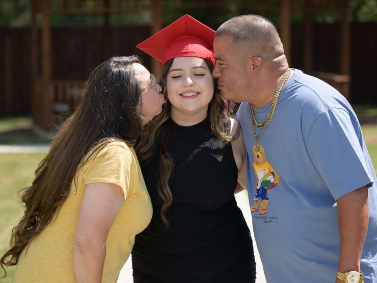 Skyline High School senior student celebrating with proud parents during a portrait session