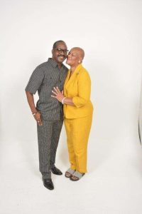 Smiling couple in coordinated outfits at a family photography studio in Dallas