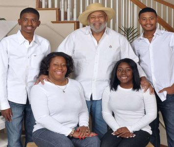 A family of four posing for a professional portrait in our Dallas photography studio.